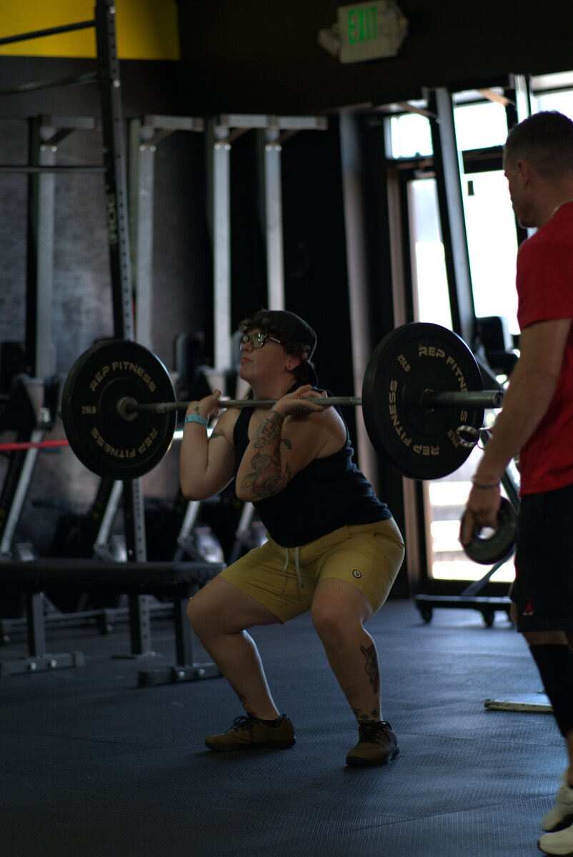 CrossFit athlete finishing a heavy squat at CrossFit Forever
